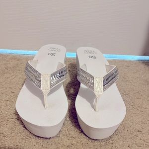 White wedge flip flops with silver beading on strap